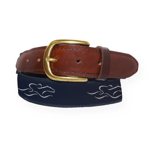 A mens signature canvas and leather belt.  Our signature navy and white EMBRACE THE RACE ribbon on a navy backiing adorned with a leather tip and brass buckle.