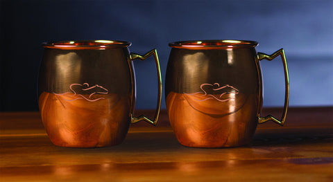 A set of 16 ounce copper mule cups with a brass handle and beautifully etched with the EMBRACE THE RACE icon.