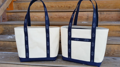 A heavy duty canvas tote bag.  Fully lined with navy liner to match the custom EMBRACE THE RACE ribbon sewn handles and solid navy canvas bottom.
