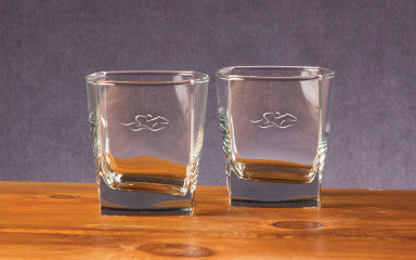 A set of 10 ounce square rocks glasses etched with the EMBRACE THE RACE icon.